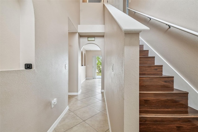 stairs featuring tile patterned floors