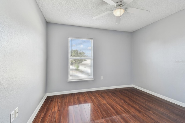 unfurnished room featuring ceiling fan, dark wood-type flooring, and a textured ceiling