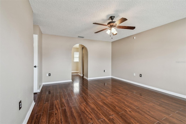 6213 Venezia Pl, Riverview, FL 33578 - empty room featuring ceiling fan, arched walkways, a textured ceiling, and dark wood-style floors