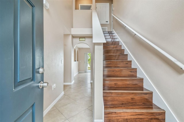 stairway featuring tile patterned flooring