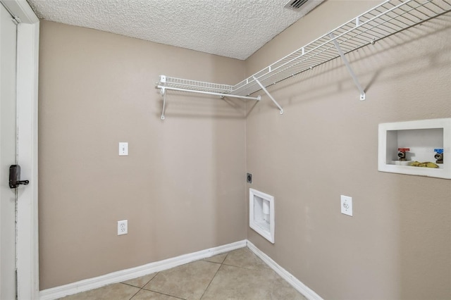 laundry room featuring light tile patterned floors, washer hookup, a textured ceiling, and hookup for an electric dryer