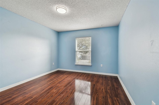 unfurnished room with hardwood / wood-style floors and a textured ceiling