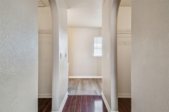 hallway with hardwood / wood-style flooring