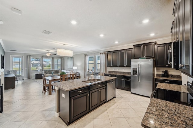 kitchen featuring stone counters, sink, stainless steel appliances, crown molding, and a kitchen island with sink