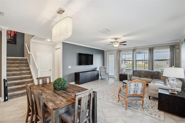 dining area featuring light tile patterned floors, ceiling fan with notable chandelier, and ornamental molding