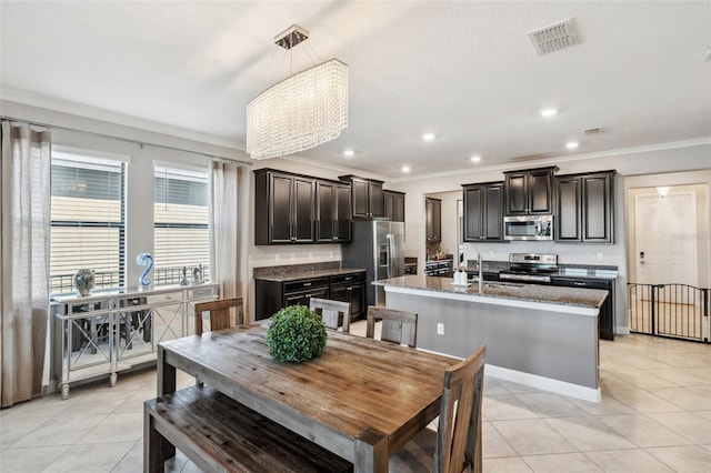 tiled dining space with a notable chandelier, ornamental molding, and sink