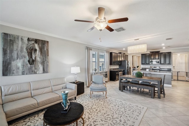 tiled living room with ceiling fan, crown molding, and sink