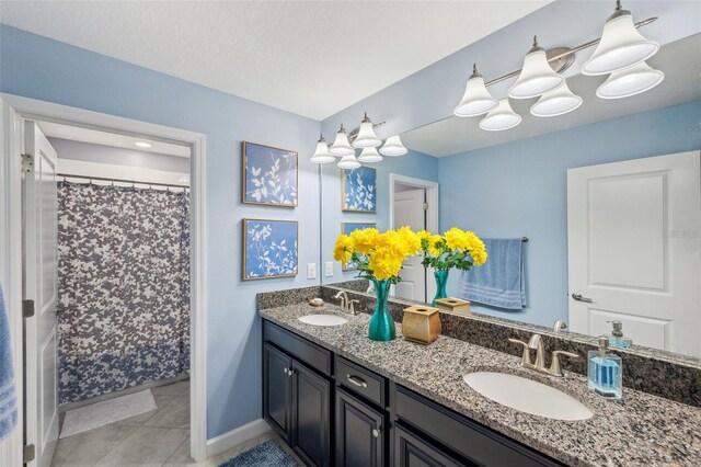 bathroom featuring tile patterned flooring and vanity