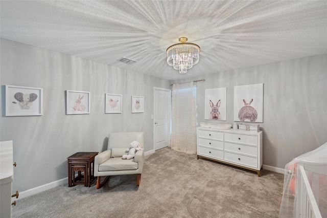 sitting room featuring light carpet, a textured ceiling, and an inviting chandelier