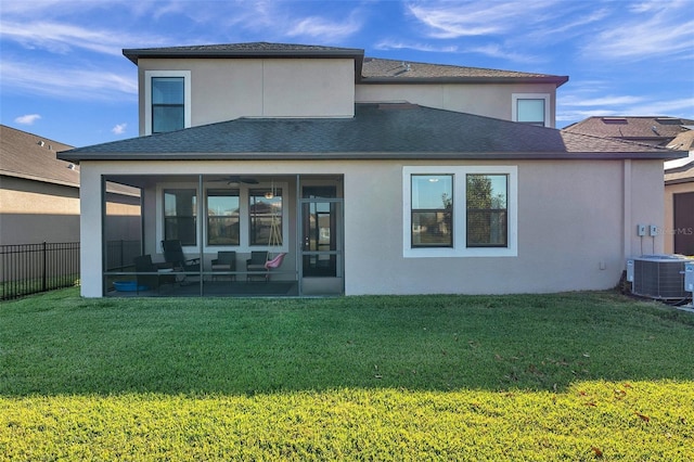 back of house with a yard, central AC unit, and a sunroom