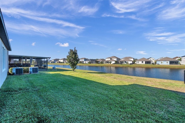 view of yard featuring a water view, cooling unit, and a sunroom