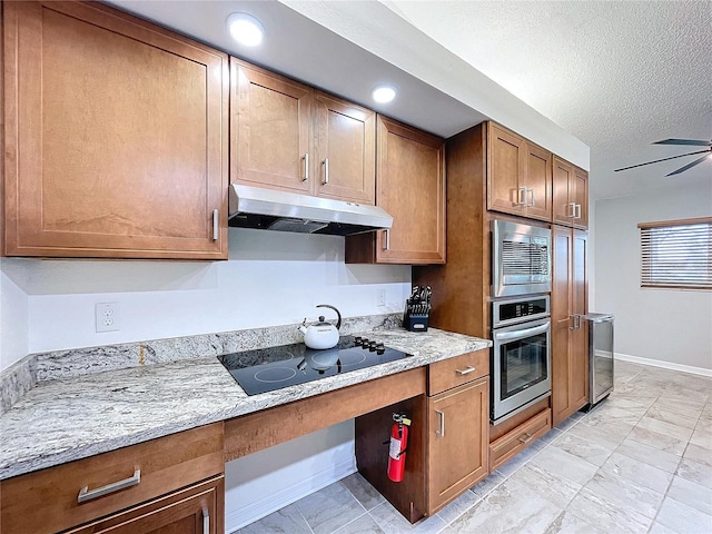 kitchen featuring light stone countertops, ceiling fan, beverage cooler, a textured ceiling, and appliances with stainless steel finishes