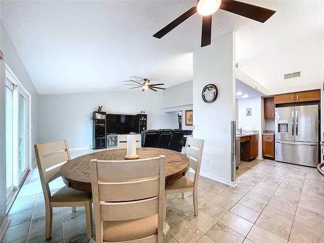 dining room featuring light tile patterned floors, a textured ceiling, a wealth of natural light, and ceiling fan