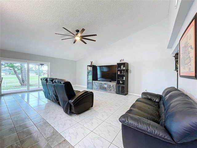 living room with ceiling fan, a textured ceiling, and vaulted ceiling