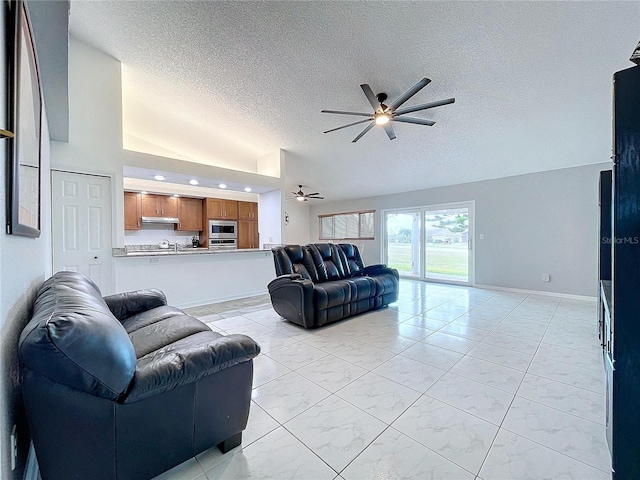 living room with ceiling fan and a textured ceiling