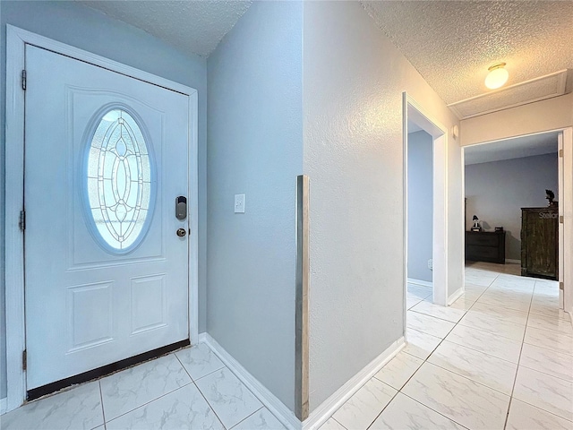 entrance foyer featuring a textured ceiling