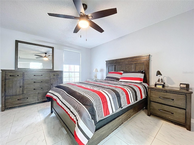 bedroom featuring a textured ceiling and ceiling fan