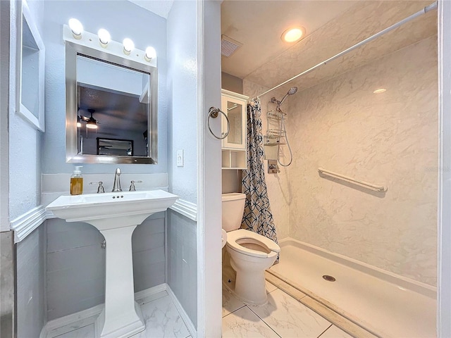 bathroom featuring toilet and walk in shower