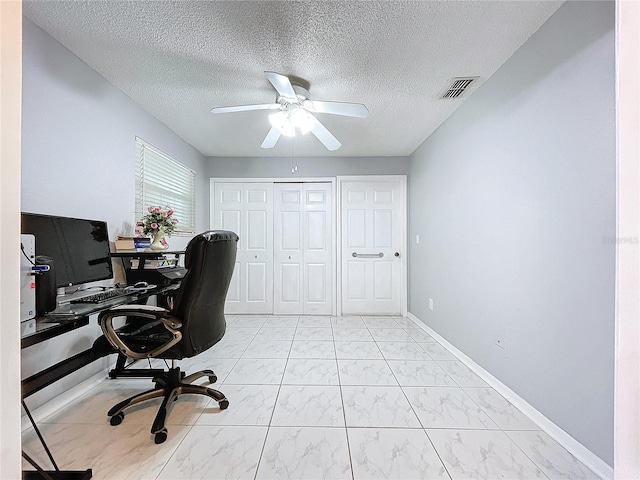 office featuring ceiling fan and a textured ceiling