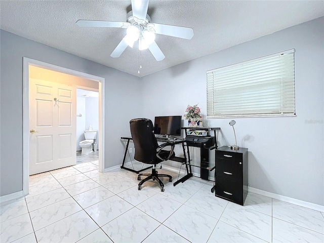 office space with ceiling fan and a textured ceiling