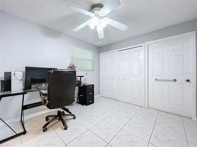 office space with a textured ceiling and ceiling fan