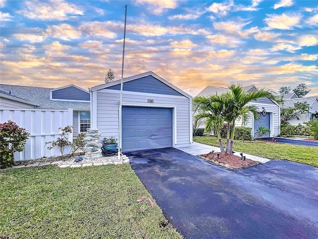 single story home featuring a yard and a garage