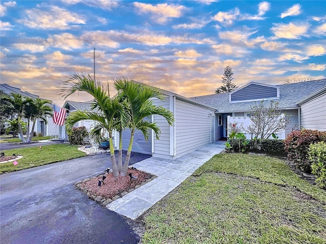 view of front of home featuring a garage and a yard