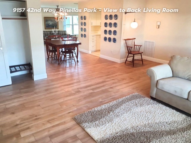 living room featuring hardwood / wood-style flooring and a chandelier