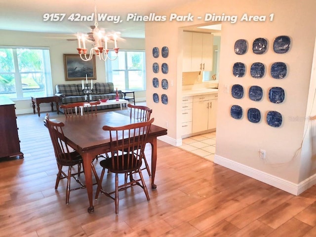 dining area featuring a notable chandelier and light hardwood / wood-style floors