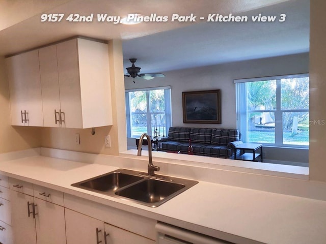 kitchen with white cabinetry, sink, and ceiling fan