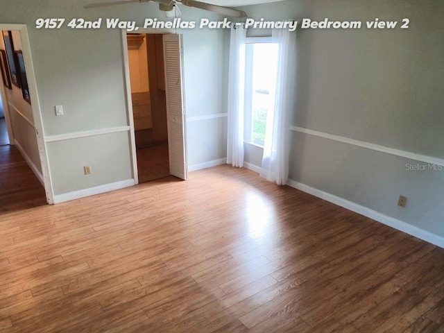 empty room with ceiling fan and light wood-type flooring