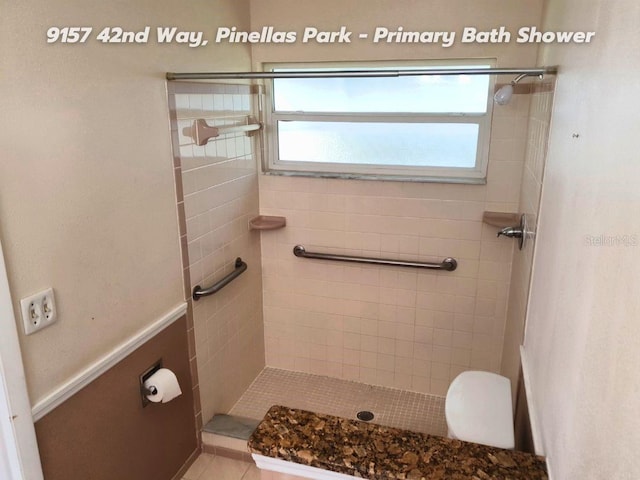 bathroom featuring plenty of natural light and a tile shower