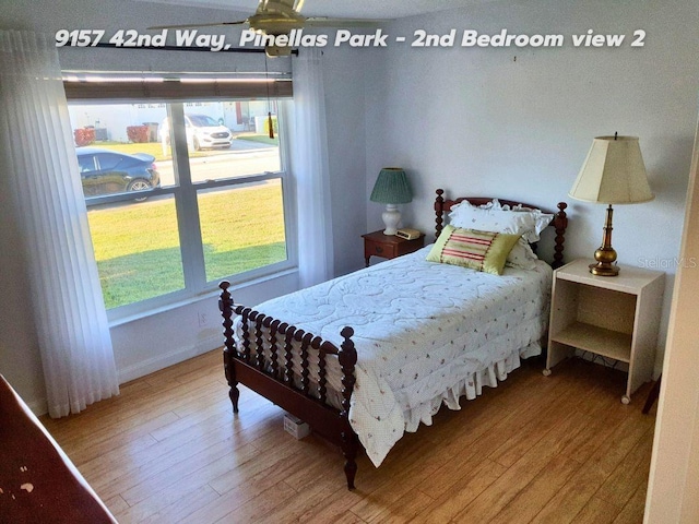 bedroom with multiple windows and wood-type flooring