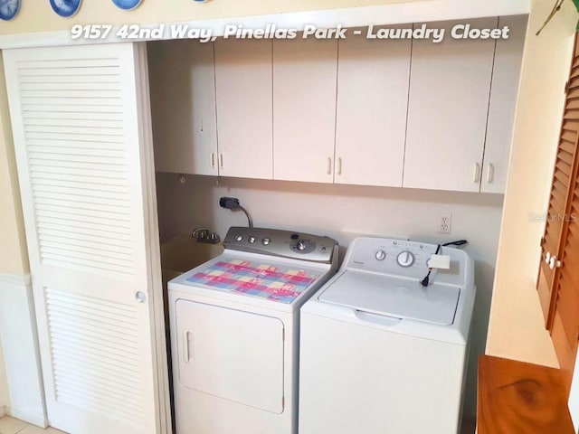 laundry room with cabinets and washing machine and clothes dryer