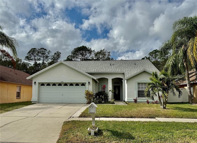 single story home with a garage and a front lawn