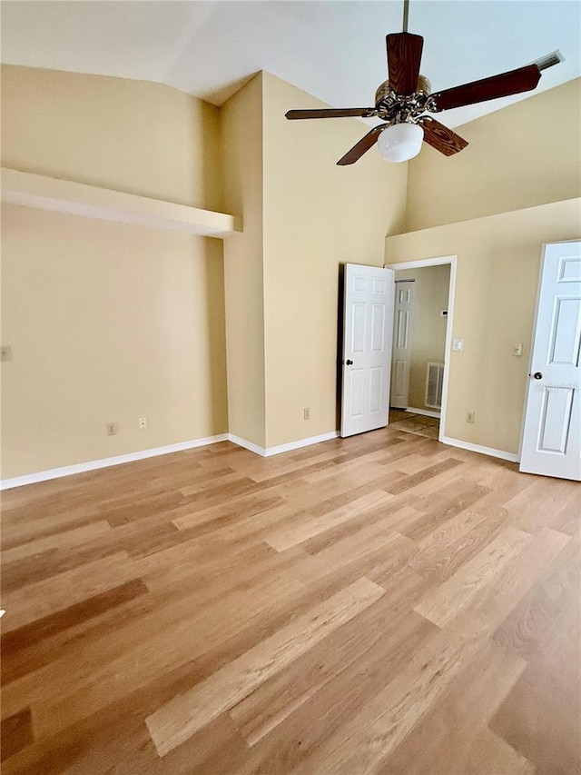 interior space featuring light hardwood / wood-style flooring, high vaulted ceiling, and ceiling fan