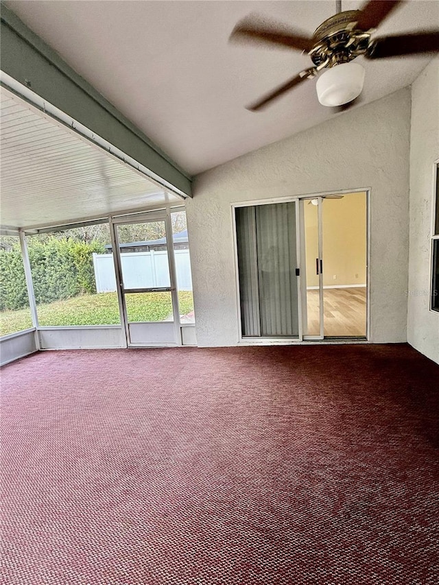 unfurnished sunroom with ceiling fan and lofted ceiling