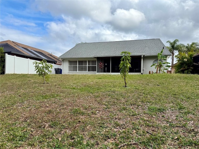 back of property featuring a yard