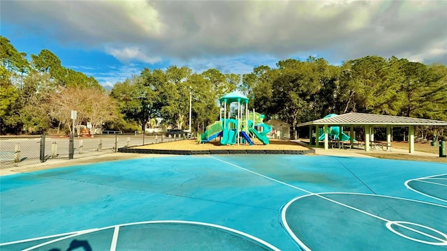 view of basketball court featuring a playground