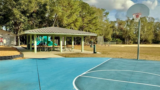 view of sport court featuring a playground