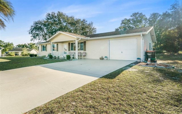 ranch-style home featuring covered porch, a front yard, and a garage