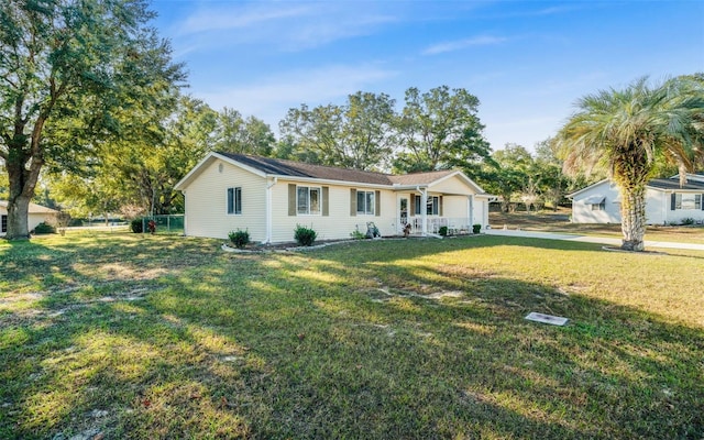 single story home with a porch and a front lawn