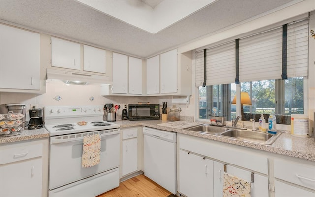 kitchen with light wood-type flooring, white appliances, a textured ceiling, sink, and white cabinets