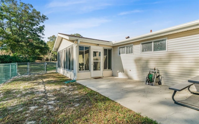 back of house featuring a sunroom and a patio