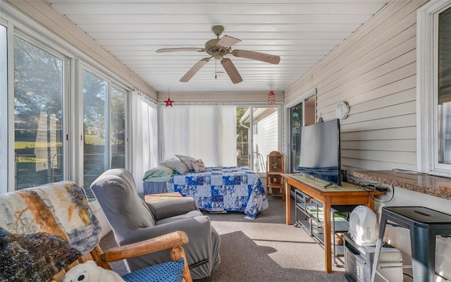 sunroom featuring ceiling fan