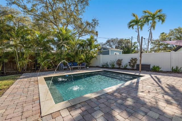 view of pool with pool water feature and a patio area