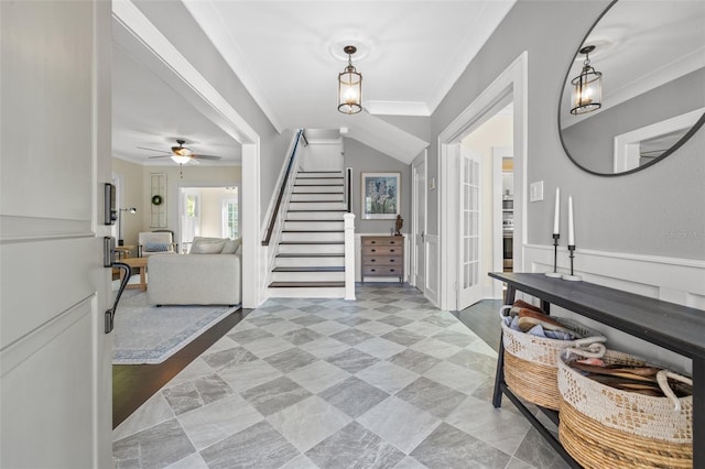 foyer featuring ceiling fan and ornamental molding