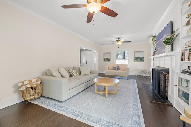 living room with ceiling fan, ornamental molding, and dark wood-type flooring