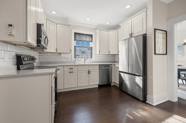 kitchen featuring white cabinets, decorative backsplash, sink, and appliances with stainless steel finishes