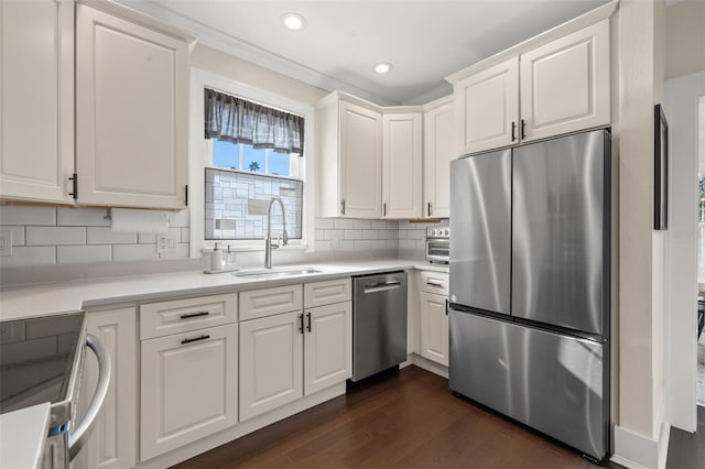 kitchen featuring tasteful backsplash, white cabinetry, sink, and appliances with stainless steel finishes